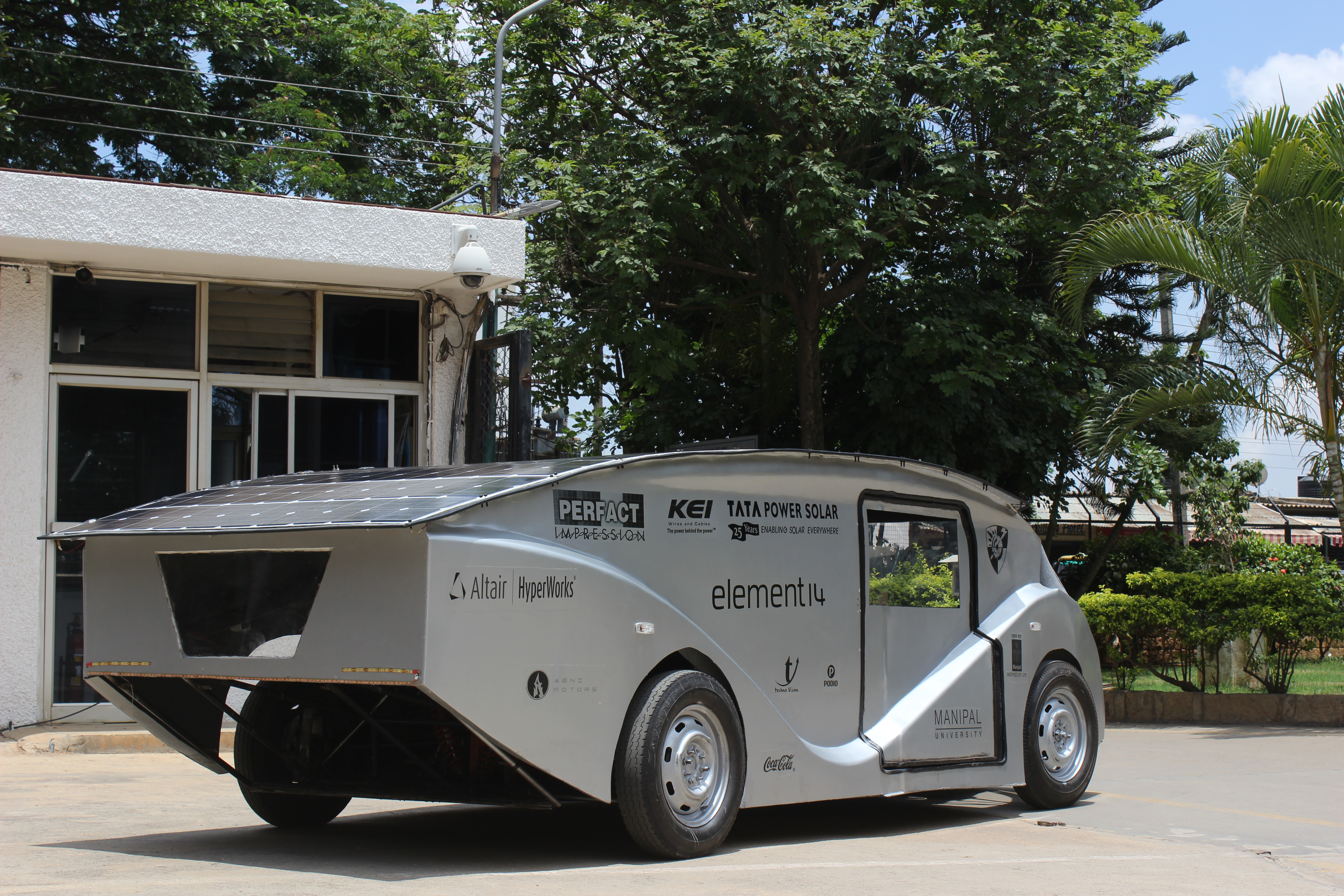 SolarMobil's cruiser class vehicle, SERVE, a white, futuristic-looking car with a rounded canopy, on display.