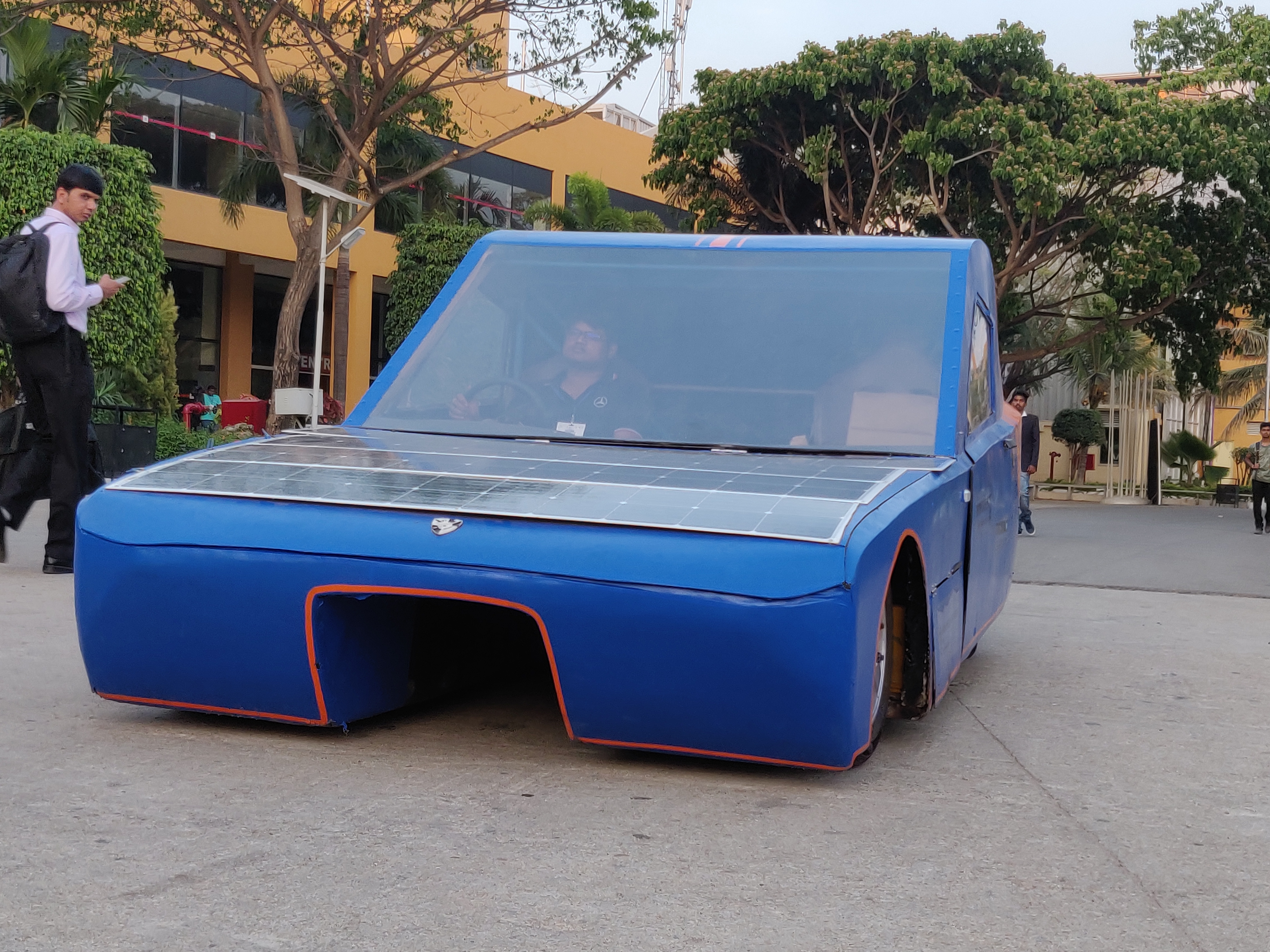 SolarMobil's SM S-2 solar car, a sleek, blue, two-seater cruiser class vehicle designed for endurance racing.